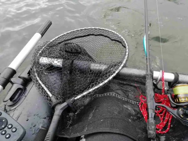 Łowienie na muchę z belly boat. Bezpieczne rzucanie sznurem z wody wymaga wprawy. Widoczny podbierak, wędka i kołowrotek.